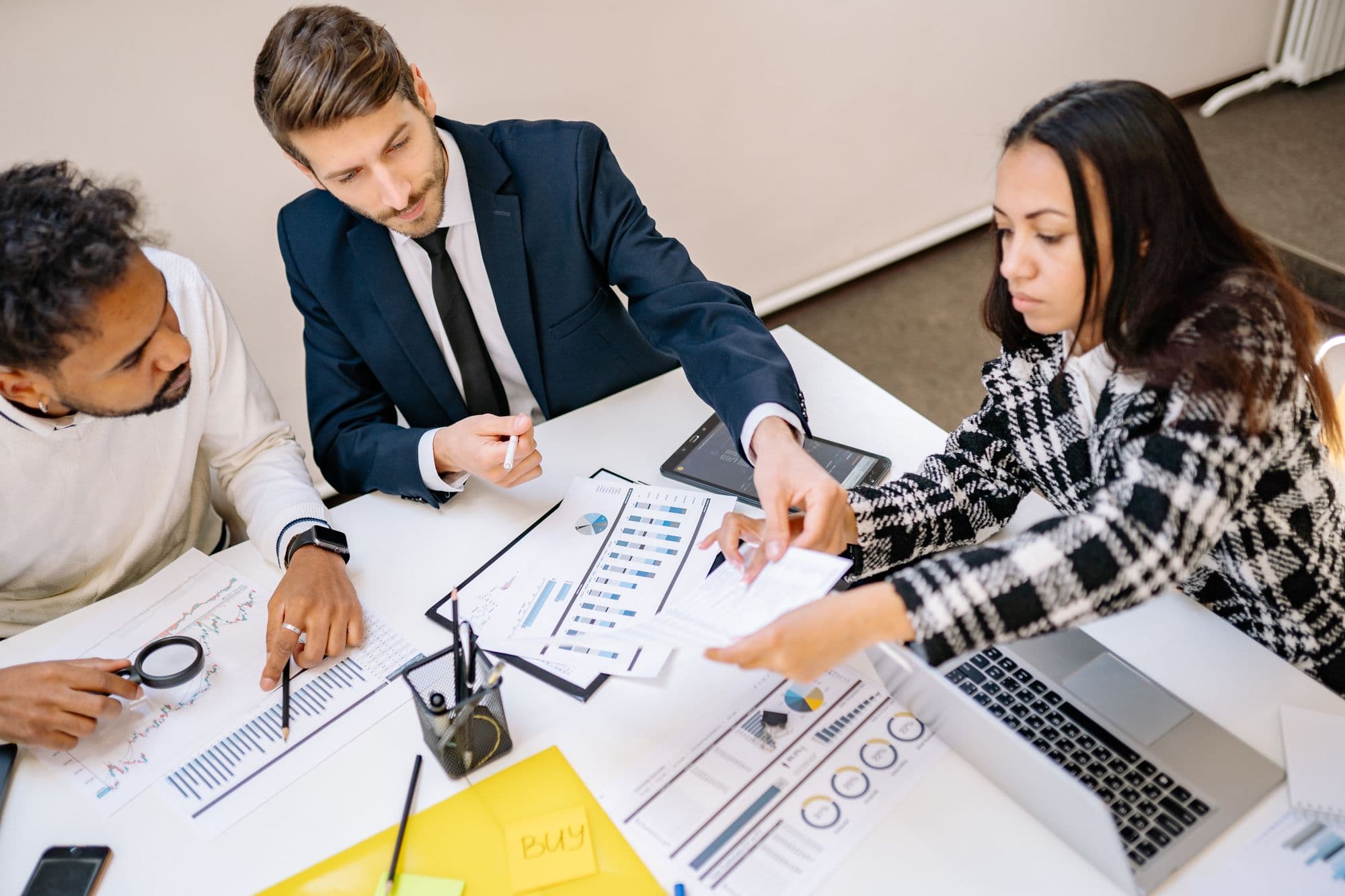 A small team reviewing financial documents together around a desk